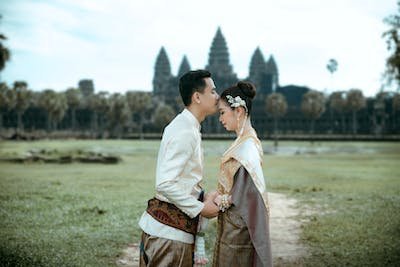 free-photo-of-a-couple-in-traditional-clothing-standing-in-front-of-a-temple
